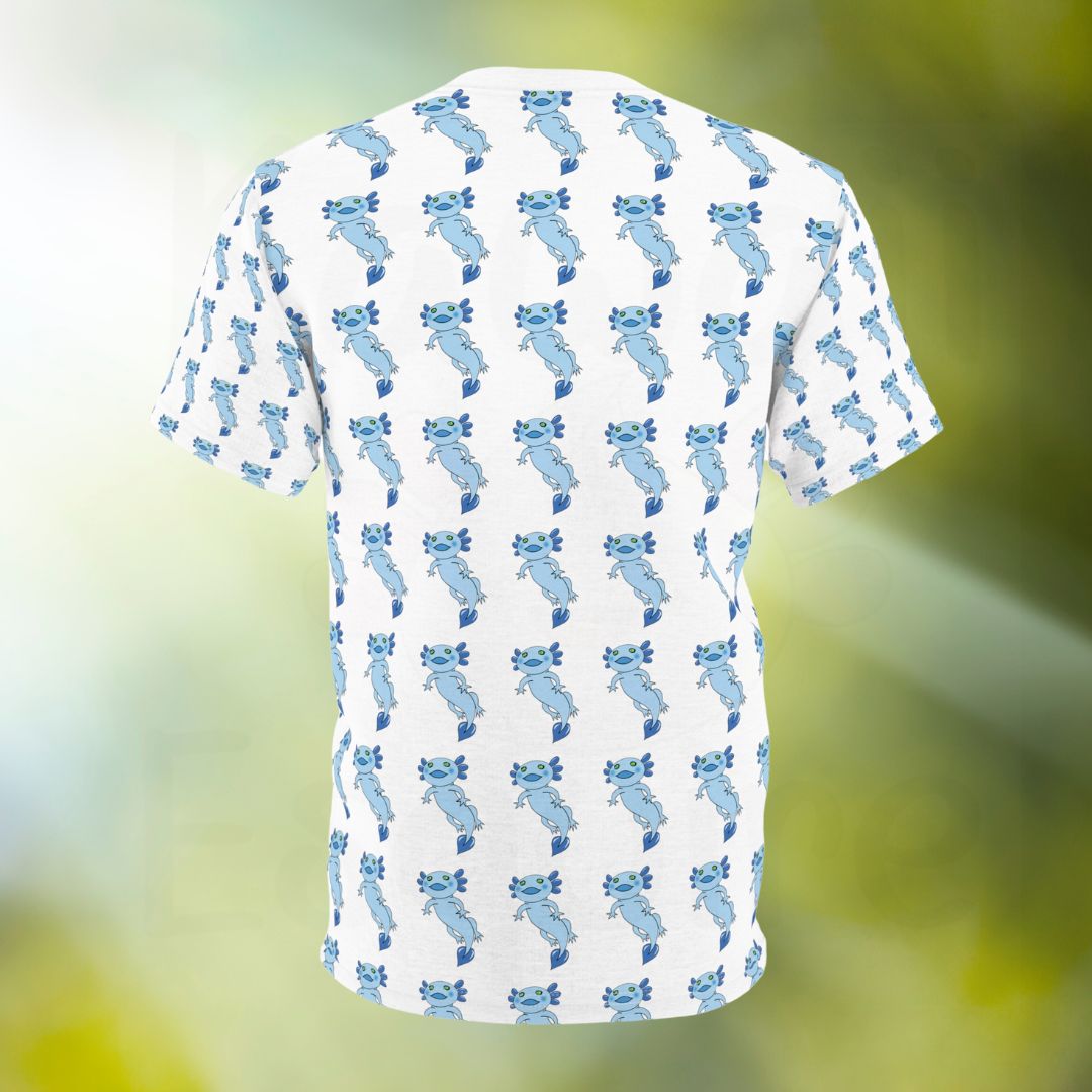 The image shows the back of a white t-shirt featuring an all-over print design of a blue axolotl. The entire back of the shirt is covered with a repeating pattern of small blue axolotls with green eyes, arranged in a consistent grid-like manner. The background is blurred, putting the focus on the t-shirt's design.