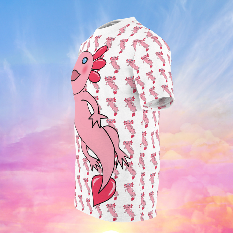 The image displays a side view of an all-over print t-shirt featuring a cute pink axolotl design. The background of the shirt is white with a repeating pattern of smaller pink axolotls scattered throughout. The large pink axolotl with blue eyes and red frills remains a prominent feature, now shown from a side perspective. 
