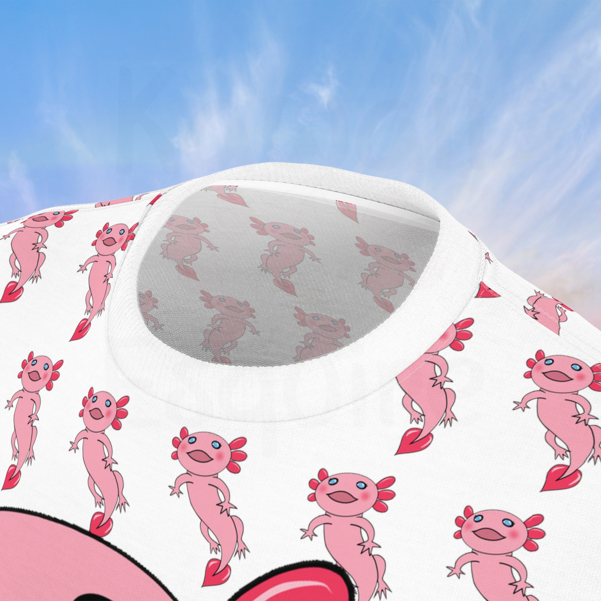 The image shows a close-up view of the neckline of an all-over print t-shirt featuring a cute pink axolotl design. The background of the shirt is white with a repeating pattern of smaller pink axolotls. The close-up highlights the detailed pattern around the collar area, showing the consistency and quality of the print. 