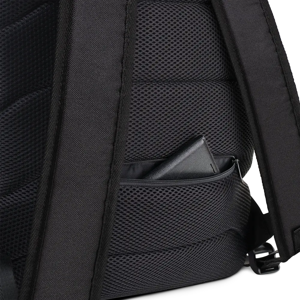 Close-up view of the back panel of a backpack, showing the padded, breathable black mesh material for comfort. A hidden zippered pocket is partially open, revealing a wallet inside, offering a secure storage option. The black straps and durable stitching provide additional support and functionality for everyday use.