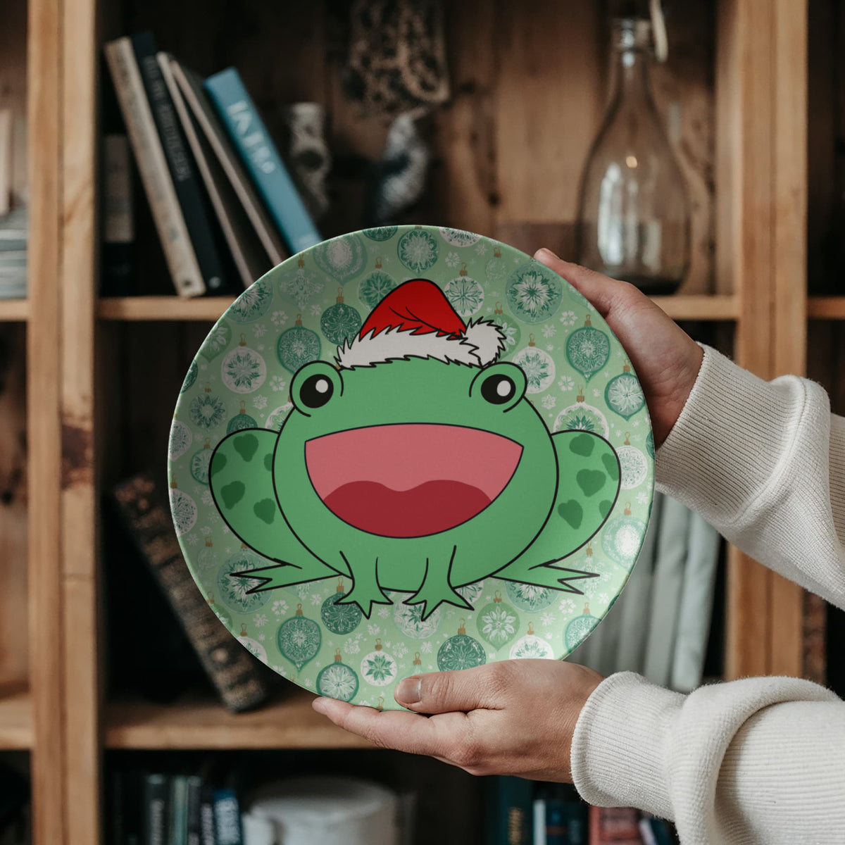 Person holding Christmas frog holiday dinner plate