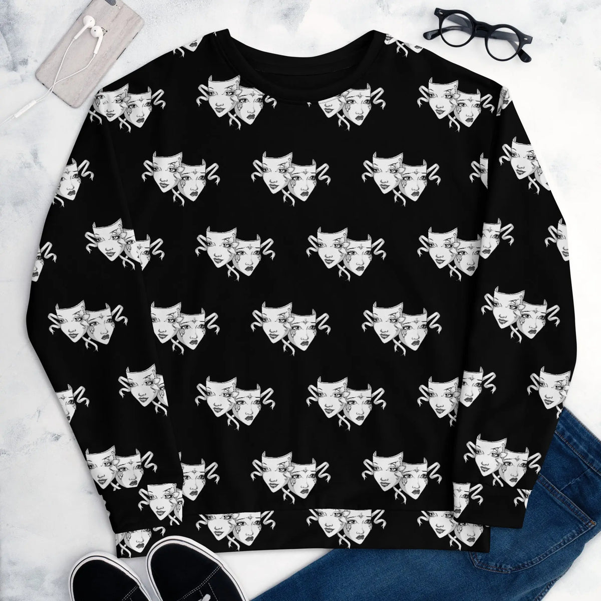 All-over print unisex black sweatshirt featuring an artistic duality of drama masks in a repeating black and white pattern. The design showcases expressive faces representing joy and sorrow. The sweatshirt has a soft cotton-feel face and a brushed fleece interior for added comfort