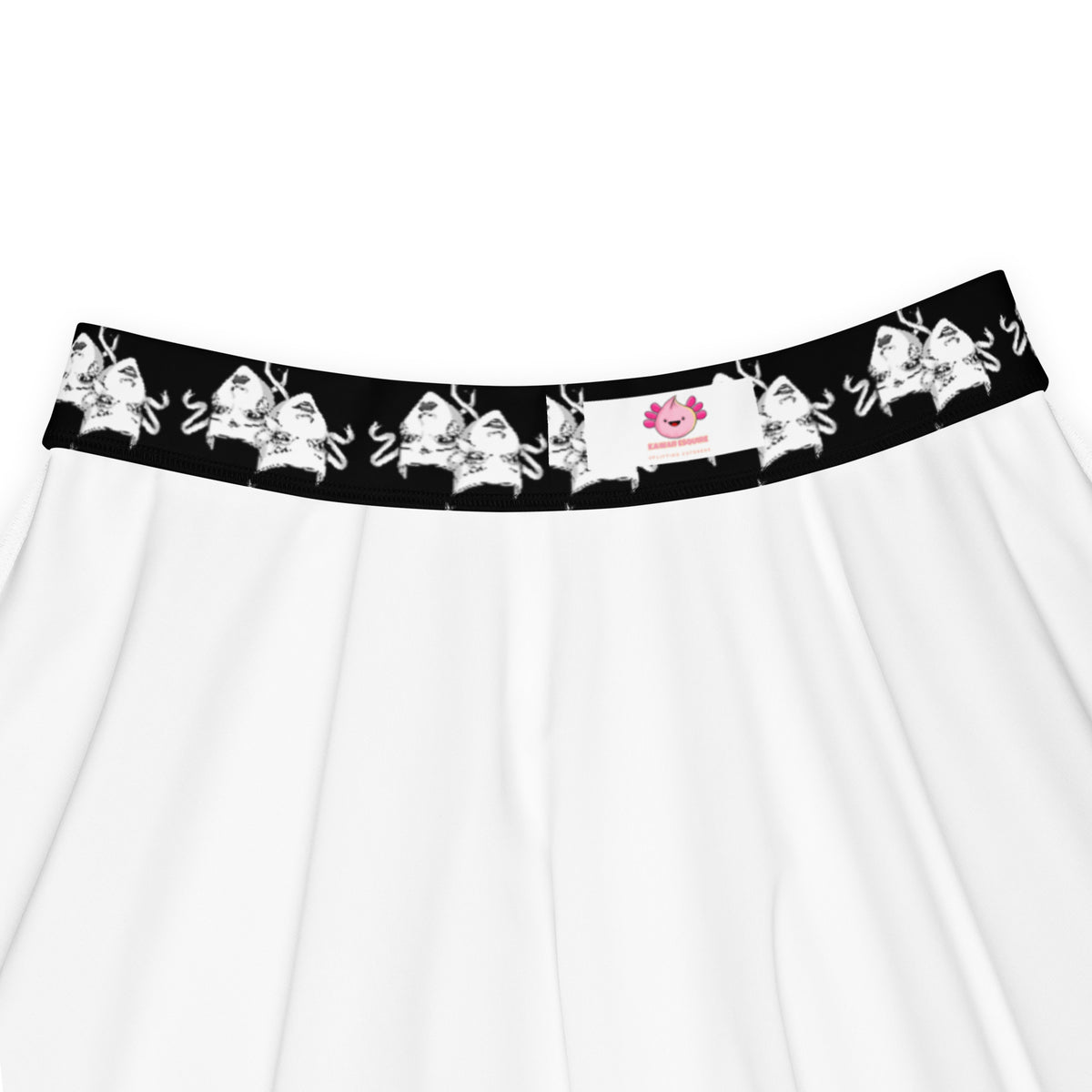 Detailed waistband view of skater skirt featuring black and white theater mask print and Kawaii Esquire logo tag. Highlights fabric texture, inner stitching, and brand label