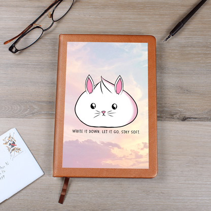 Cute bunny journal with pastel sky background and the phrase 'Write it down, let it go, stay soft', vegan leather lined notebook for self care and mental health.