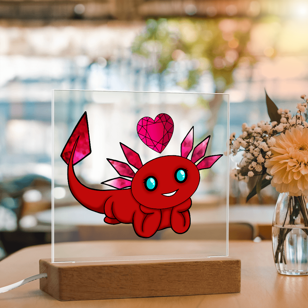 January birthstone axolotl acrylic plaque displayed on a table beside a flower vase