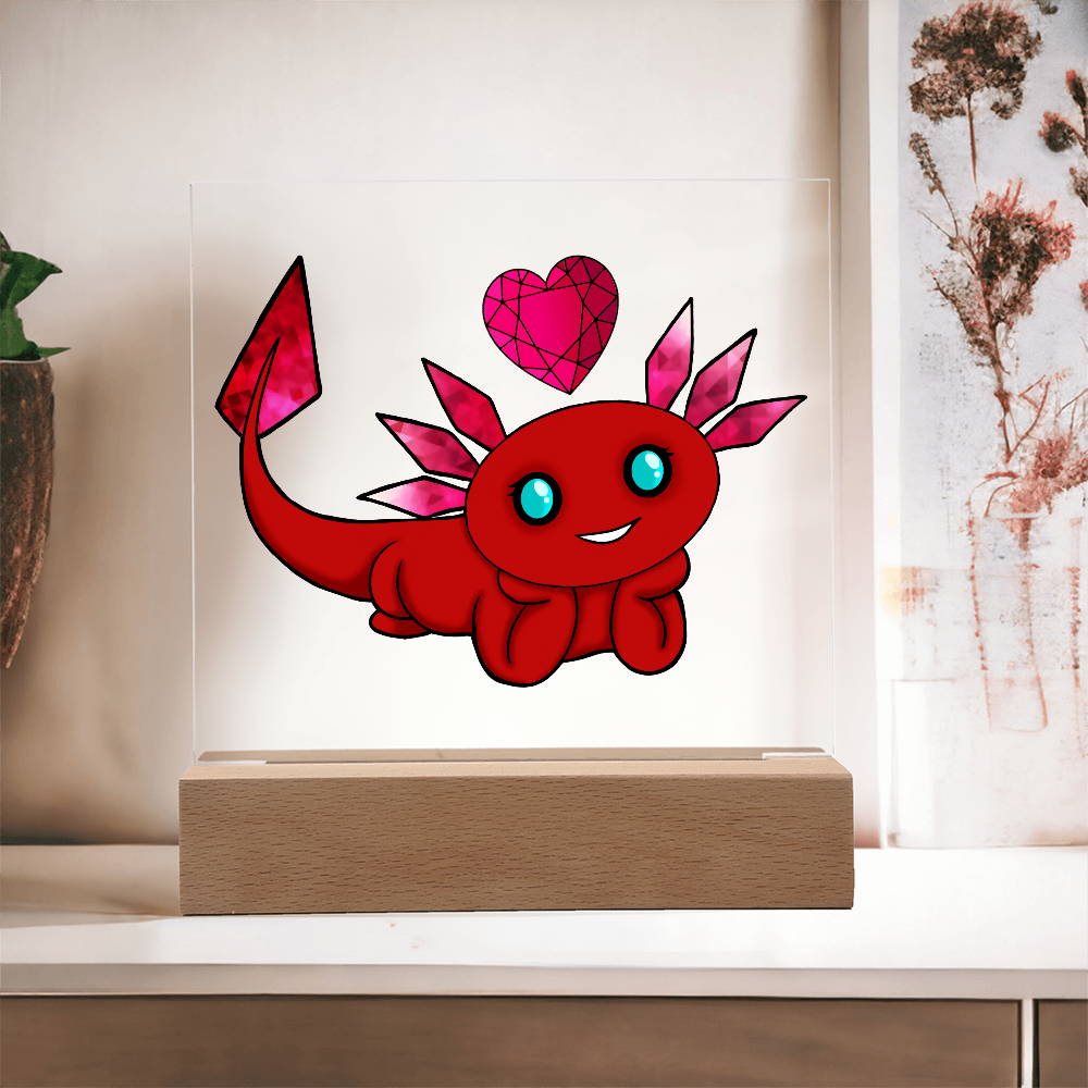 Red axolotl with pink garnet-inspired crystal gills and heart on a clear acrylic display