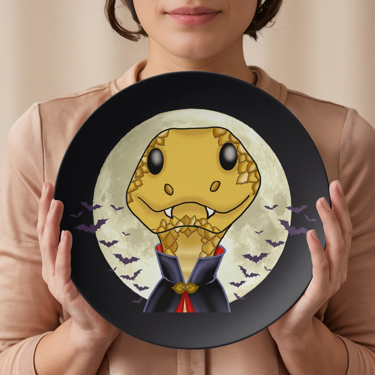 Hands holding Vampire Snake 10 inch plate