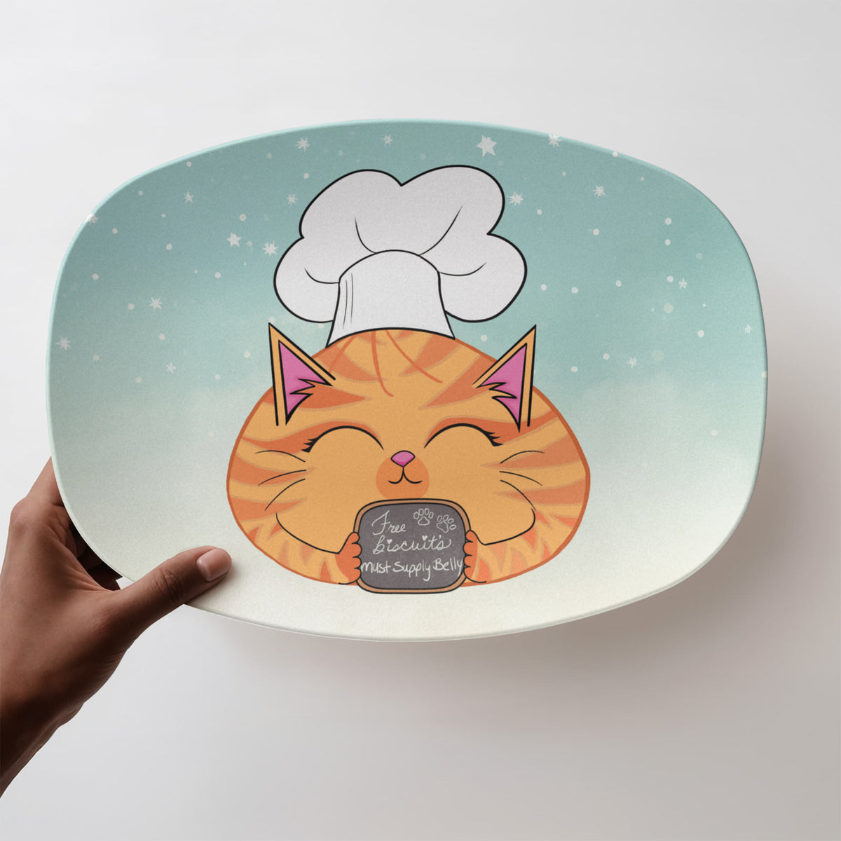 Orange tabby cat serving platter with chef hat, aqua background, and Free Biscuits Must Supply Belly sign