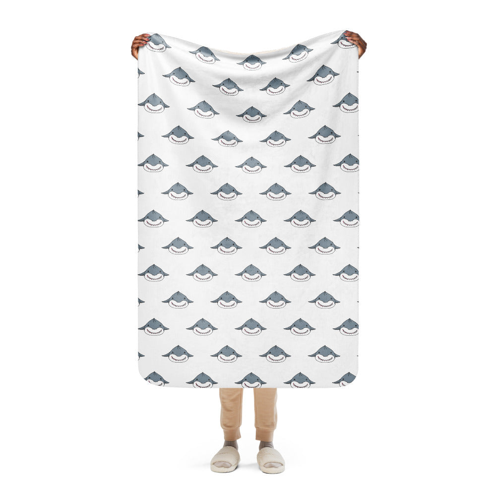 Soft and cozy sherpa blanket featuring a cute shark pattern with a smooth white surface and plush sherpa backing, perfect for warmth and style.